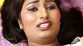 Indian mature woman gets intimate with a younger man in a wax-filled room.
